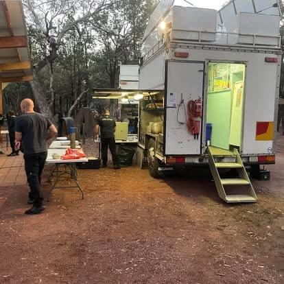 Chef Skills mobile kitchen serving a camp at dusk in the Victorian bush.